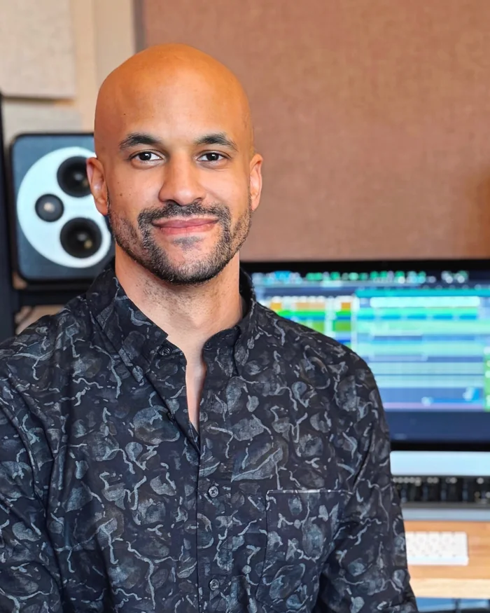 Jonathann Rice at the desk in his San Francisco studio, monitors and a running session behind him.